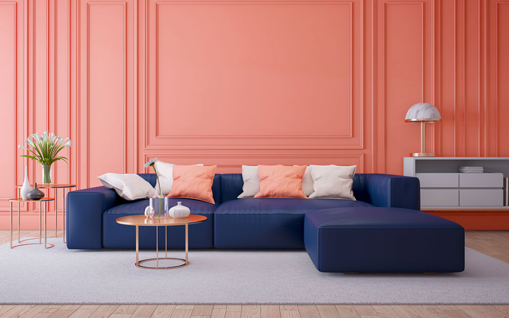 A-living-room-Costal-blue-colour-shofas-and-wall-painted-with-Coral