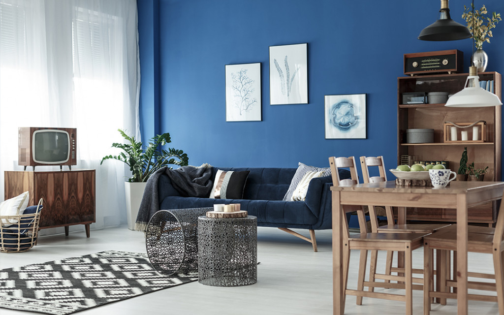living-room-coloured-with-dark-blue-and-decorated-by-wall-frames
